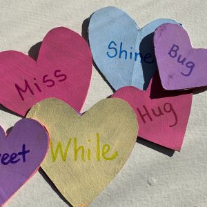 Sensory play with rhyming words - painted hearts with rhyming pair words